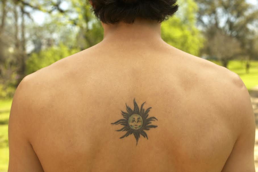 Man with sun tattoo on his back